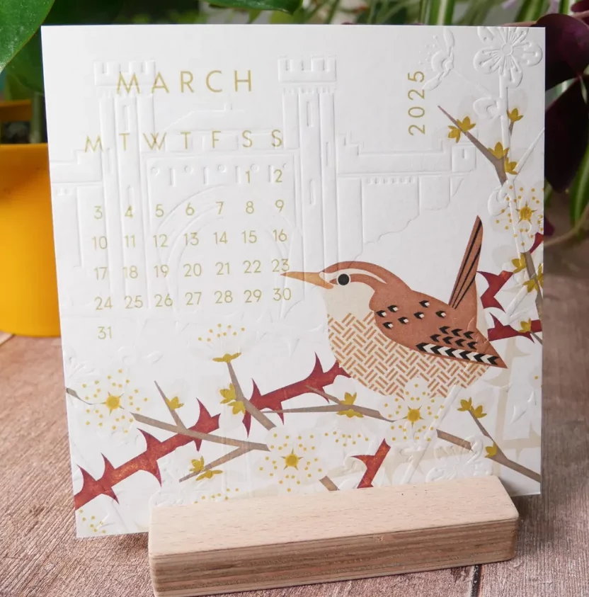 Physical calendar with embossed texture on recycled paper
