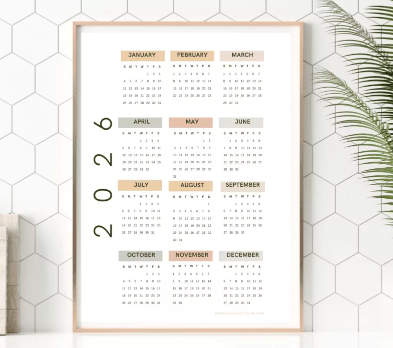 Selection of 2026 wall calendars styled in a living room and workspace setting